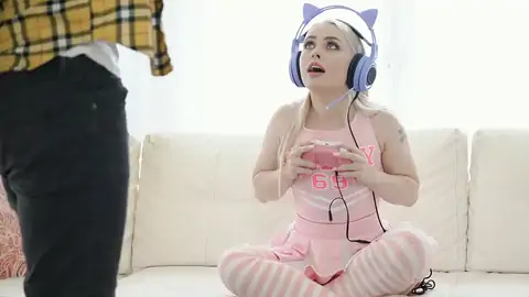 Cosplaying blondie wearing headphones while gaming